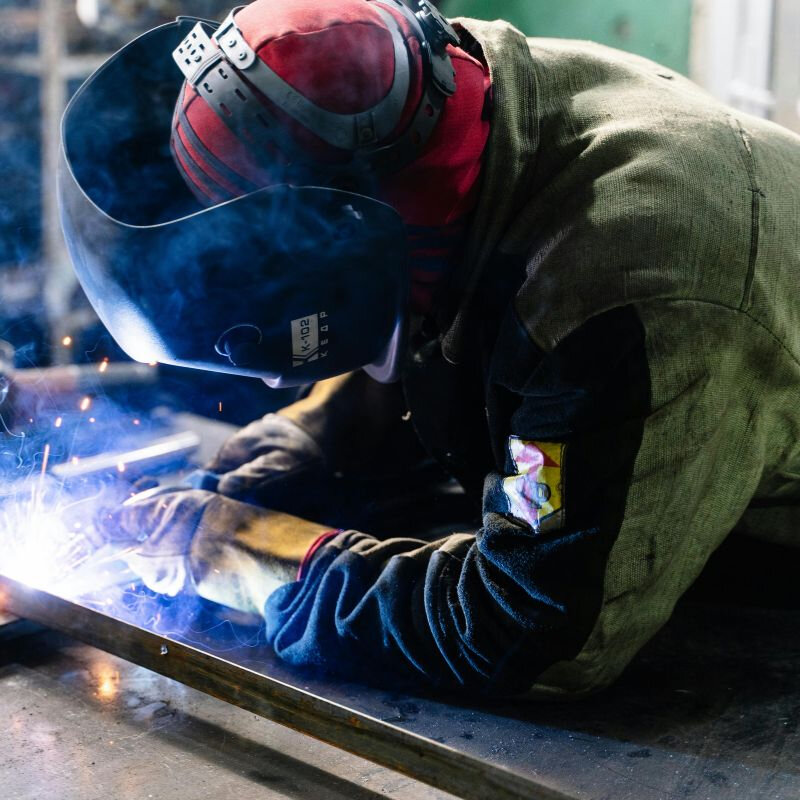 a welder working on a work piece with metal forming techniques